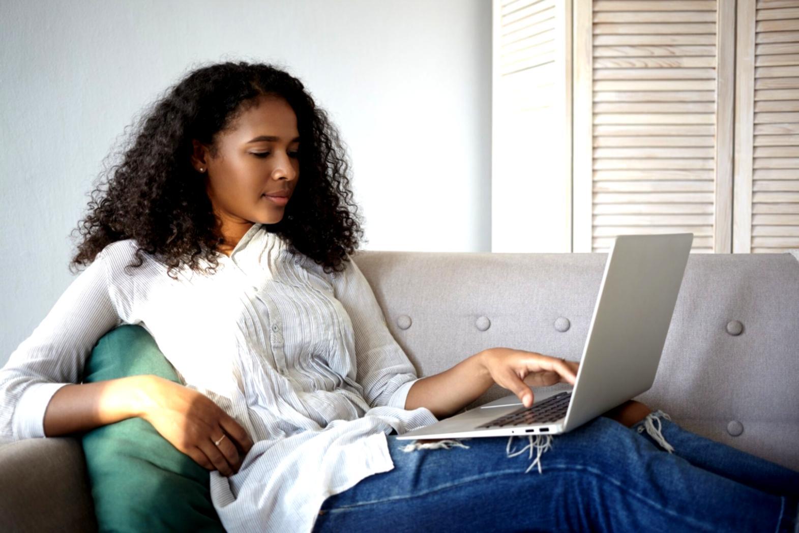 Group of diverse professionals collaborating around a conference table with financial documents and laptops